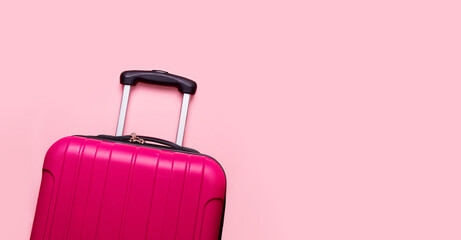 Suitcase on a pink background. Banner. The concept of travel, vacation, luggage packing. Copy space