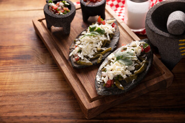 Tlacoyos and Nopales. Mexican pre hispanic dish made of blue corn flour patty filled with refried beans. Popular street food in Mexico