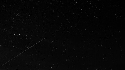Astronomical long exposure photography of stars with a meteor or shooting star