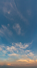 Naklejka na ściany i meble Fantastic clouds at sunrise, vertical panorama