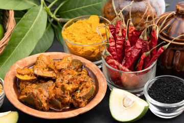 Mango Pickle Also Called Aam Ka Achar, Sookha Kairi, Chatpata Loncha Is Made of Unpeeled Raw Green Mango Cut Mixed With Spices - Garlic, Masala, Red Chilli, Salt, Turmeric, Sarson, Mustard, Sarso Oil