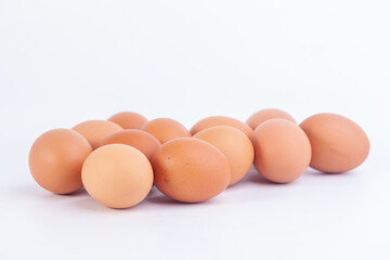 Several chicken eggs are placed on a white background...
