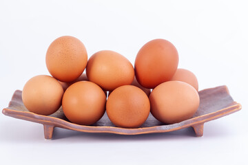 chicken eggs lies in a japaness ceramic saucer on white background.