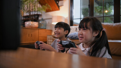 Family concept of 4k Resolution. Children are having fun playing games together in the house.