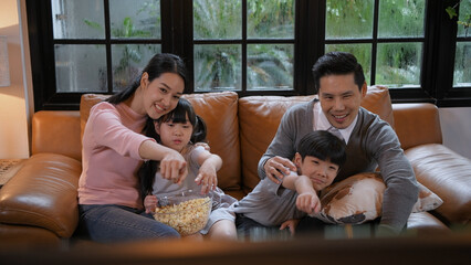 Family concept of 4k Resolution. Asian parents and children watching movies together at home on...