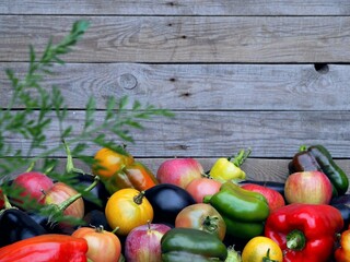 Autumn natural background. Fresh vegetables and fruits are stacked in a pile on a natural wooden background.Harvesting vegetables.