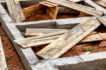 Dismantling the strip foundation formwork at the construction site. Dismantling of wooden formwork...