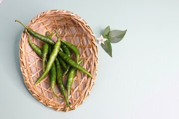 Farm fresh organic Green chili peppers. Freshly harvested healthy and spicy chilies in a basket on...