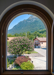 View through a window on an alpine landscape