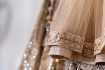 Indian Punjabi bride's creamy wedding outfit textile, fabric and pattern close up