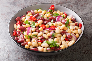 Vegetarian salad of three beans close-up in a bowl on the table. Horizontal
