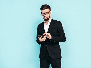 Handsome confident stylish hipster lambersexual model. Sexy modern man dressed in elegant black...