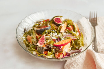 Mediterranean salad with fresh arugula, grain rustic cheese, batata and figs. Healthy appetizer, fresh vegan salad
