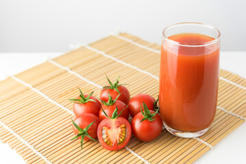 FFresh tomato drink on wood background , high vitamin A and beta carotene, red vegetable juice