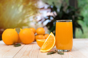 glass of fresh orange juice with fresh fruits on wooden table, high Vitamin C, orange drink