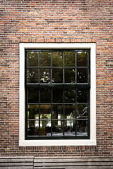 Wooden window in a brick wall