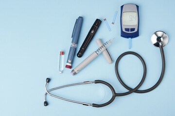 Diabetes concept with medical equipment on blue background