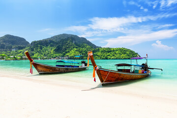 Thai traditional wooden longtail boat and beautiful sand beach at Koh Phi Phi island in Krabi...