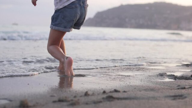 Close-up of a little girl's feet on the beach.