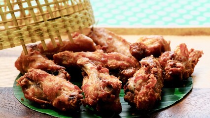 Deep fried chicken with Thai wooden cover.