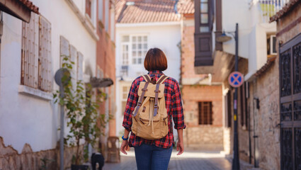 travel to Turkey, old town Antalya Kaleci Famous tourist destination . Happy asian female tourist traveller with backpack walks in old city.