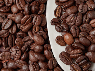 Coffee cup and coffee beans on a wooden background. View from above.