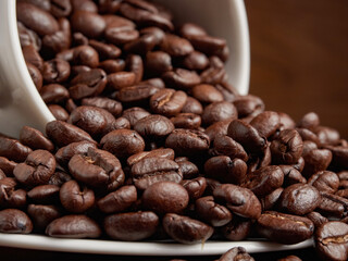 Coffee cup and coffee beans on a wooden background. View from above.