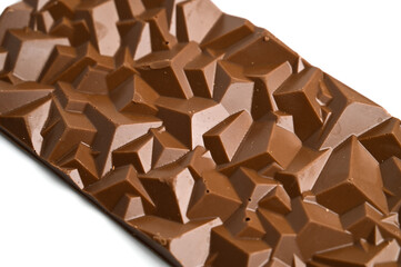 Close up a chocolate bar isolated on white. Homemade chocolate bar in polygonal shape. Chocolate confectionery
