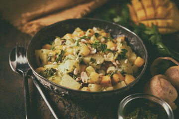 Close up of a one pot recipe with potato and mango.