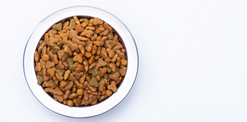Top view. Metal bowl with dry food for cats and dogs isolated on white background