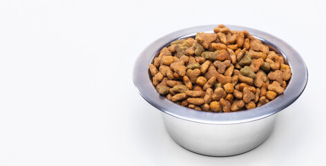 Dry granulated food in a metal bowl for cats and dogs. Animal care, vitamins and balanced pet nutrition.