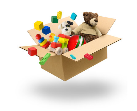 Cardboard box full of various toys levitation over white background
