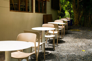 Fototapeta na wymiar Modern white chairs and table in garden.