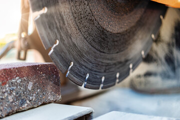 The circular diamond saw cuts concrete paving slabs. Concrete cutting machine close-up.