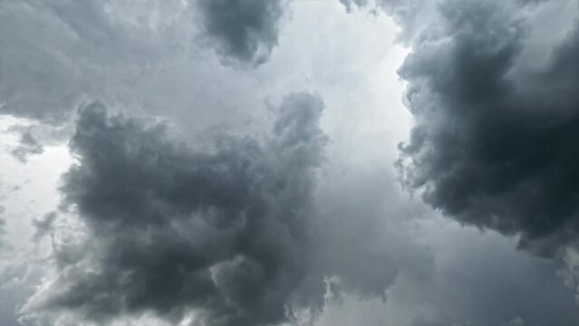 Dusty sky. Changeable weather. Aerial view. Thundery gray fluffy clouds bunching in heaven like mystery flow slow motion.