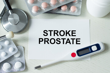 Stroke prostate text card on the doctor's desk next to a thermometer, stethoscope and tablets
