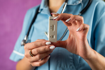 doctor or medical technician shows a rapid antibody lab test for COVID with a negative result.