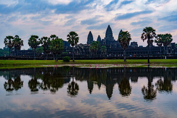 Fototapeta na wymiar Cambodia. Siem Reap Province. A silhouette of Angkor Wat (Temple City) and its reflection in the lake at early morning. A Buddhist and temple complex in Cambodia and the largest religious monument in