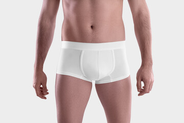 Mockup of white male boxers on the athletic body of a guy, brief underwear, isolated on background, front view.