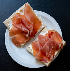 Sandwiches with sliced cured ham (hamon, jamon, prosciutto crudo), close up