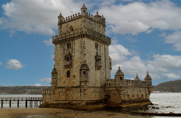 Fototapeta na wymiar Exterior view of the historical Belem tower (Torre de Belém) on Tagus River in Lisbon, Portugal, Europe. 16th-century limestone fortification, an example of the Portuguese Manueline architecture style