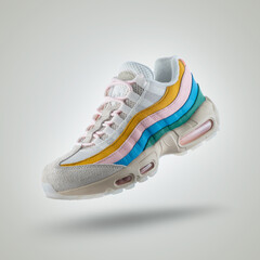White sneaker with a diversity of colors, shoe on a white gradient background, Yellow, pink, blue,...