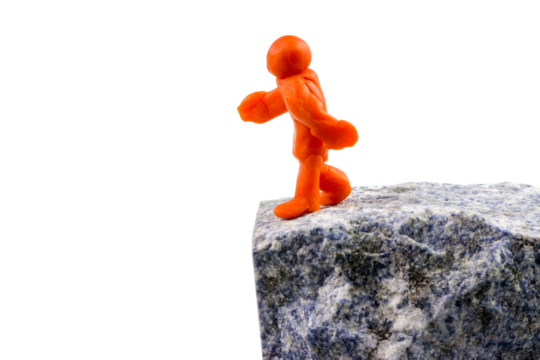 Self-made human plasticine figure walking to the edge of the abyss