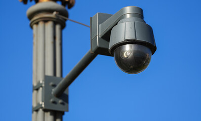 Close up view with a black 360 degree city surveillance camera. Citizen safety system used in the big cities.