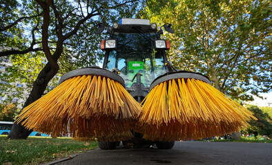 Street cleaning equipment. Closeup view of nylon brush of a road sweeper parked in the sidewalk. City management industry. 