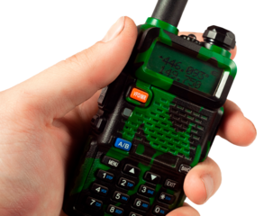 Portable radio in a human hand close up, without background