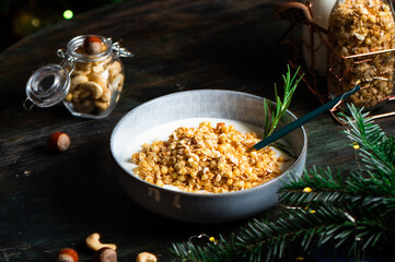 Christmas breakfast consists of granola with yogurt. Christmas muesli with nuts. Winter holidays concept. Healthy food. Oatmeal snack