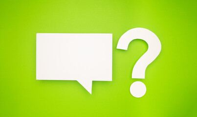 A white speech bubble and question mark symbol are on a light green background