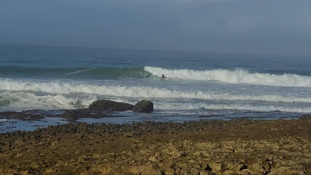close up professional Surfer on Coxos point break in Ericeira. sunny day with a good waves.