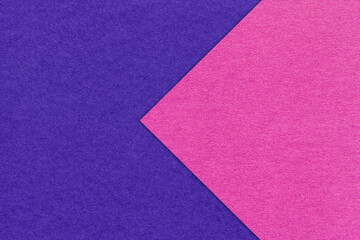 Texture of navy blue paper background, half two colors with purple arrow, macro. Structure of craft indigo cardboard